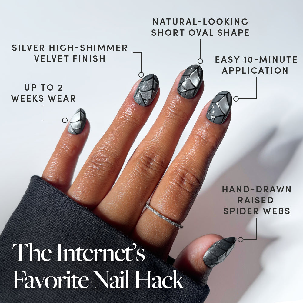 Featuring black velvet press-on nails in a short oval shape, glamnetic’s Weblings create a hand with silver shimmer spider web nail art and hand-drawn webs. Labeled benefits include 2-week wear, an easy 10-minute application, and a luxurious velvet finish—making them The Internet’s Favorite Nail Hack. - Product image