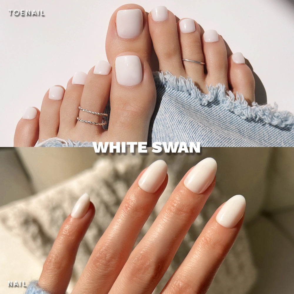 A collage features glamnetic’s White Swan Mani & Pedi: glossy white, square-shaped toenails with toe rings and distressed jeans, paired with almond press-on fingernails for a chic set. Text reads White Swan.