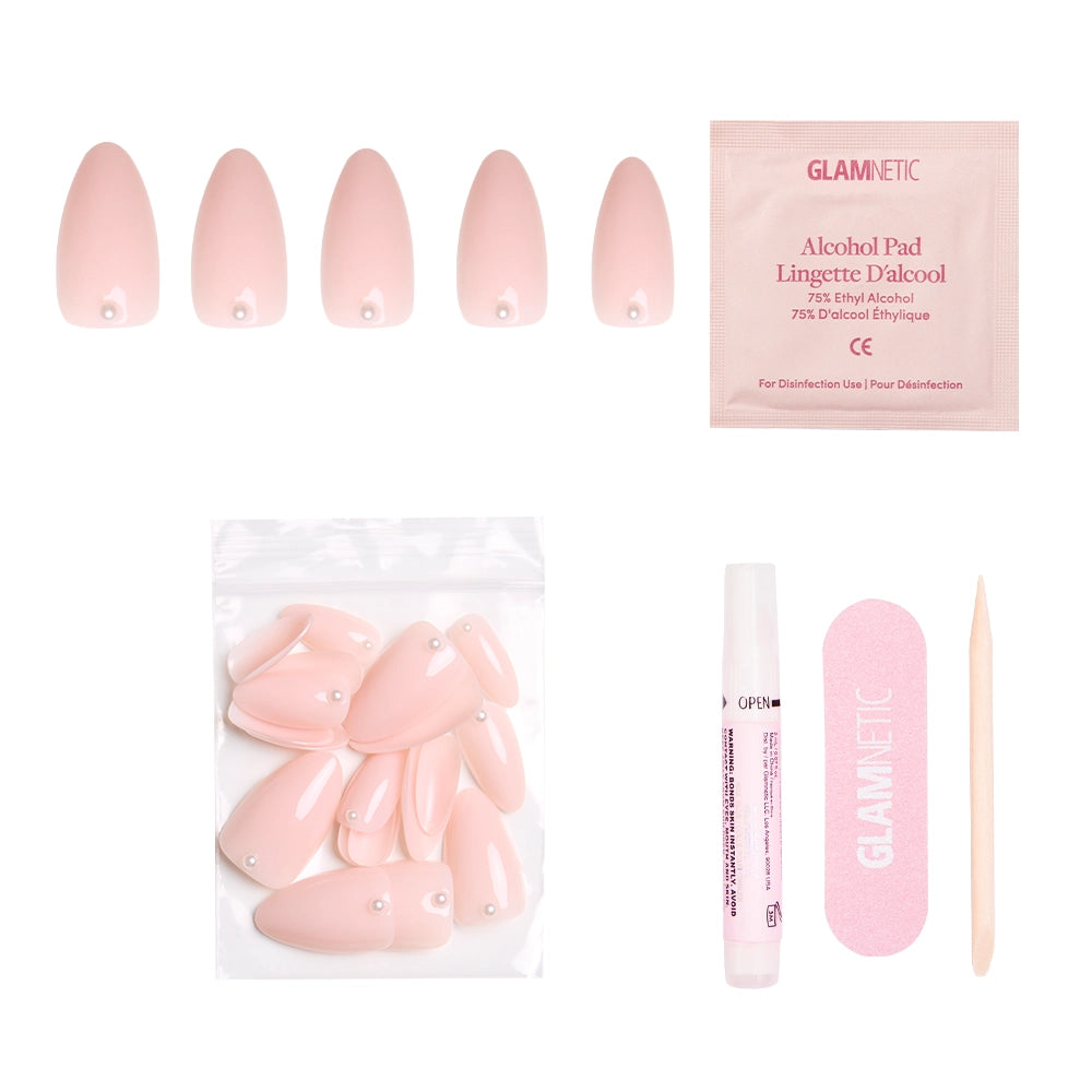 The glamnetic Wifey press-on nail kit includes pink nails with a 3D pearl design, extra nails, nail glue, a pink file, wooden cuticle stick, and alcohol pad—all shown on a white background. - Product image