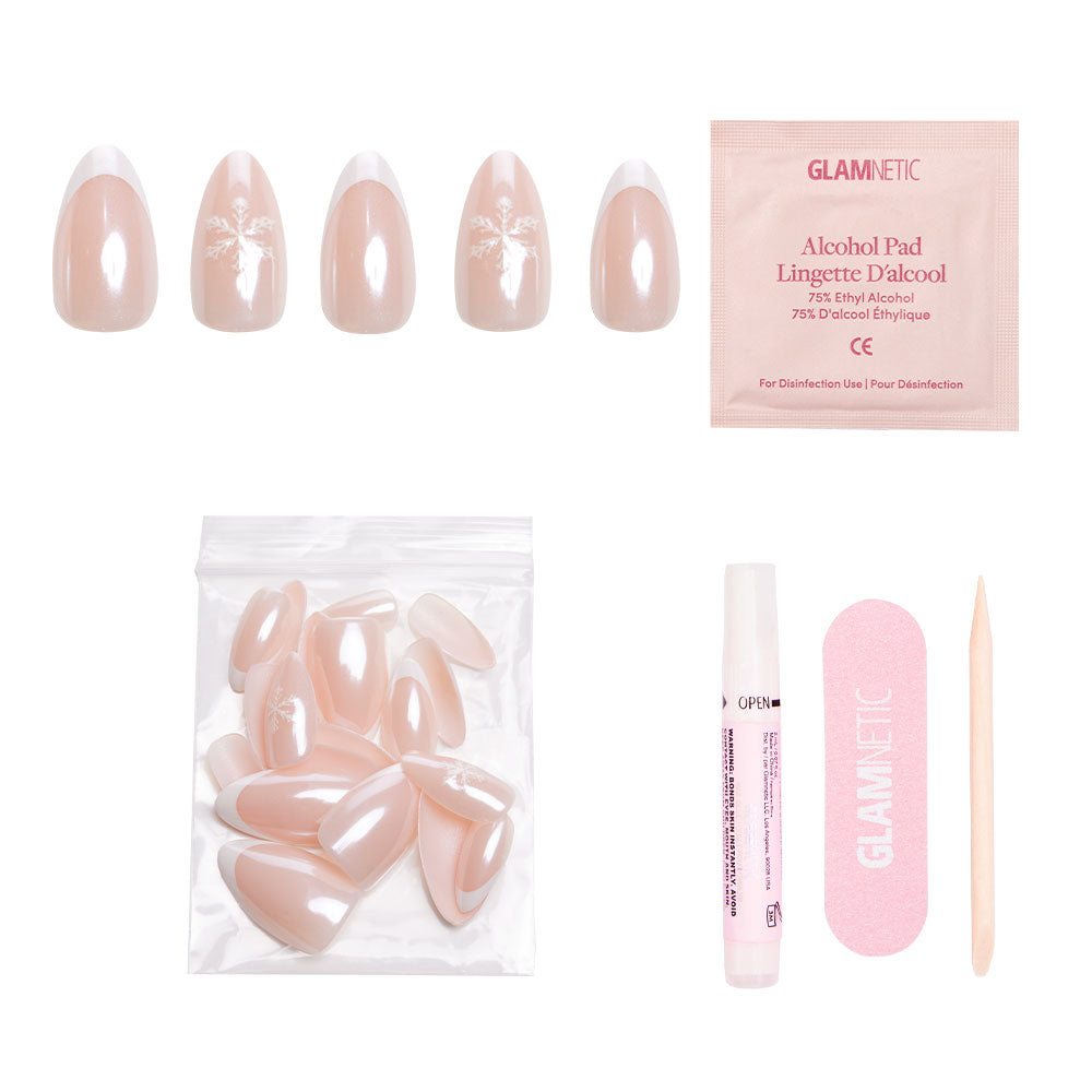 The glamnetic Winter Glaze press-on nail kit includes five blue velvet nails with snowflake designs, extra plain nails, an alcohol pad, nail glue, a pink file, and cuticle stick—all displayed on a white background. - Product image
