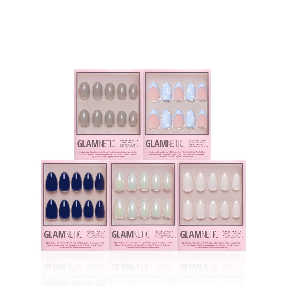 The Winter Toast Bundle by glamnetic features five boxes of cool-toned press-on nails—navy blue, light pink, iridescent white, nude, and pastel blue with white speckles—perfect for winter, arranged in two rows against a white background. - Product image