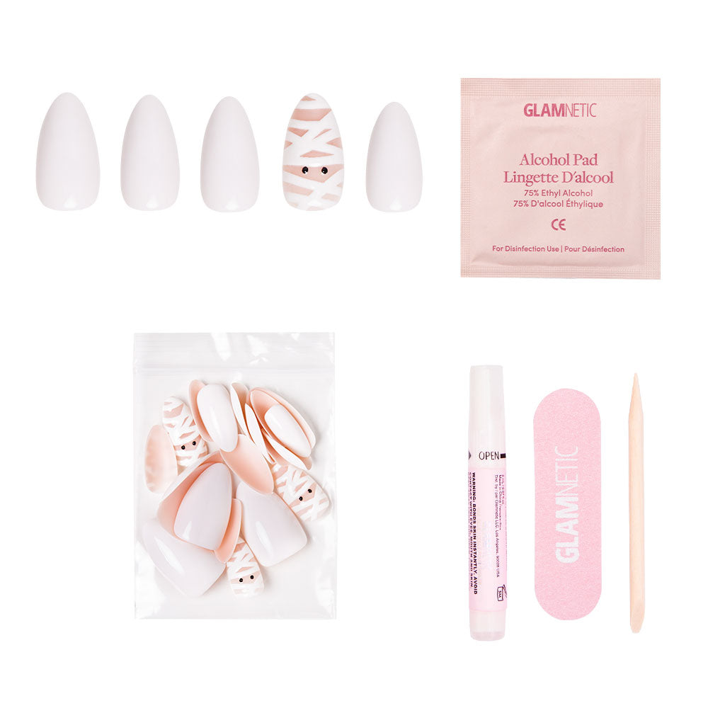 The glamnetic Wrapped Up Nail Set features short almond nails in white and mummy patterns, including a cute mummy face, and comes with all essentials in a clear bag—ideal for spooky Halloween manicures. - Product image