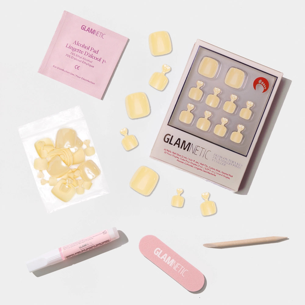 A flat-lay of the Glamnetic pastel yellow press-on toenail kit with a smooth, glossy finish and full prep set. - Product image