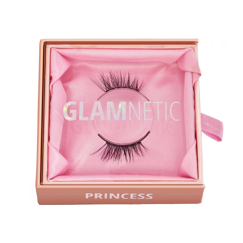 Glamnetics Princess lashes are housed in a pink box with GLAMNETIC on the clear lid and Princess on the front edge. Inside, the dramatic, reusable magnetic lashes rest on matching pink fabric. - Product image