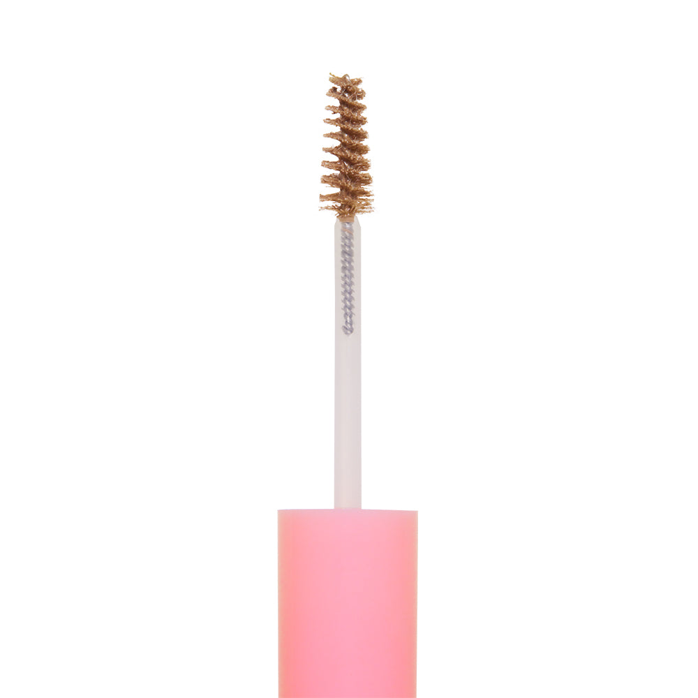A close-up of glamnetics 3-in-1 Brow It All spoolie brush with brown brow gel on the bristles, featuring a pink handle, isolated on a white background. - Product image