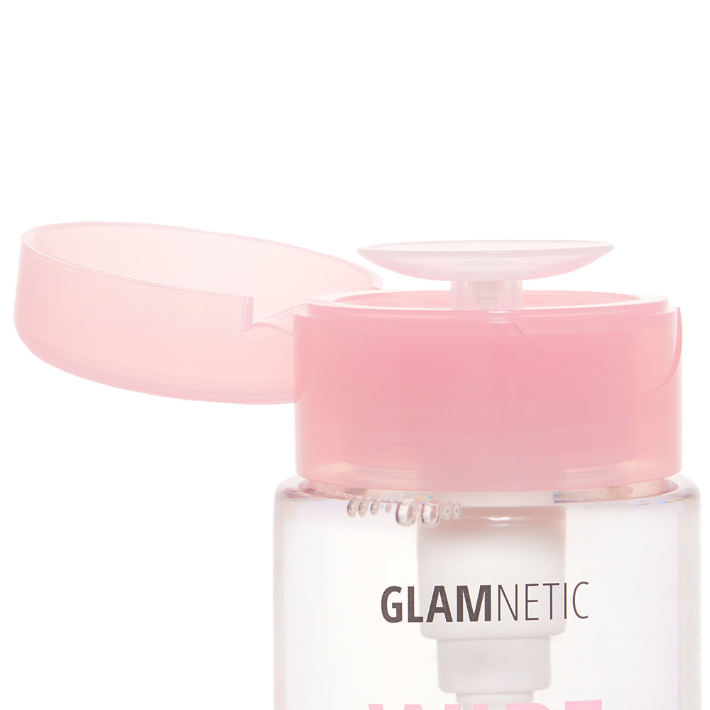An open clear bottle with a light pink flip-top cap shows the glamnetic label. This is Wipe Off by glamnetic, a makeup remover dispenser perfect for removing waterproof makeup or using as a gentle skin cleanser. - Product image