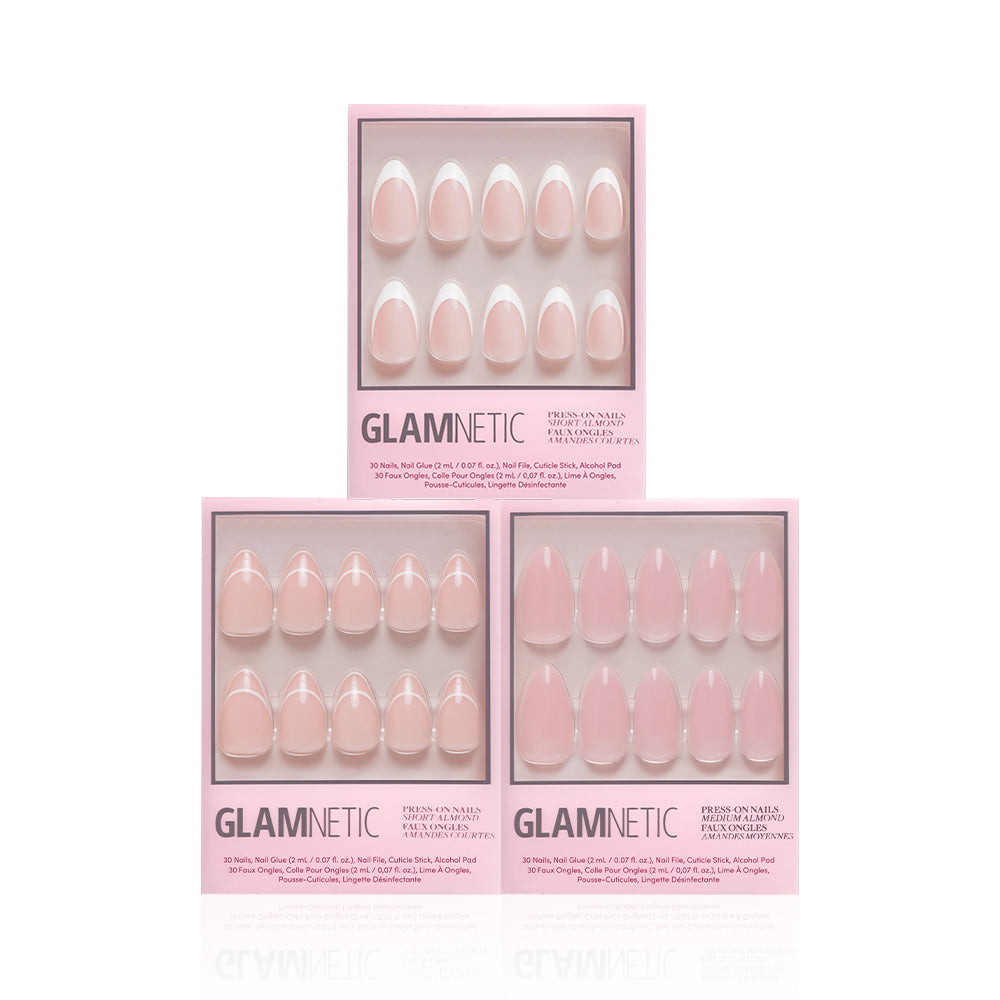 Three boxes of glamnetic Simple & Clean press-on nails are stacked in a pyramid. Each light pink box has a clear window showing the nude-colored nails inside, set against a plain white background. - Product image