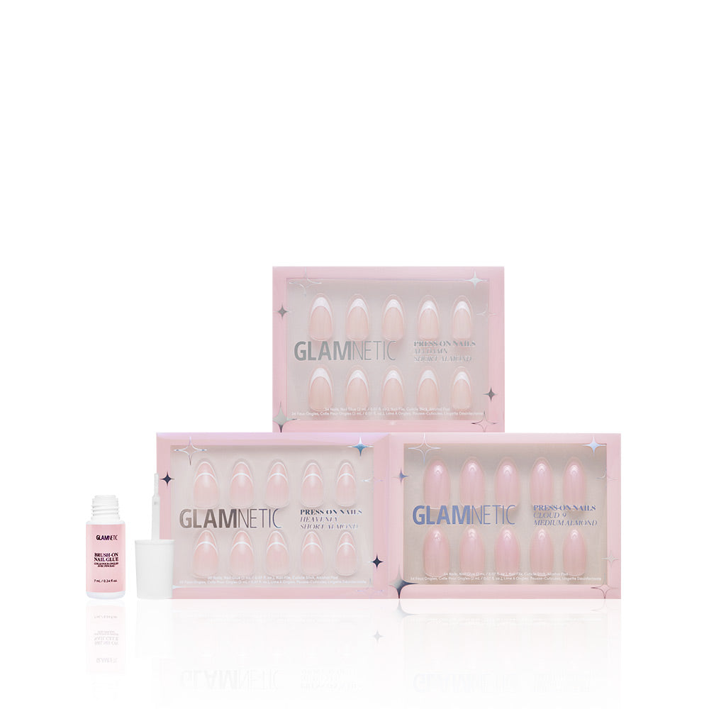 Three boxes of glamnetic press-on nails, including Ma Damn, Heavenly Cloud 9, and Simple & Clean, are stacked in soft pink shades with a Nail Glue bottle beside them against a white background. Perfect add ons for your nail routine. - Product image