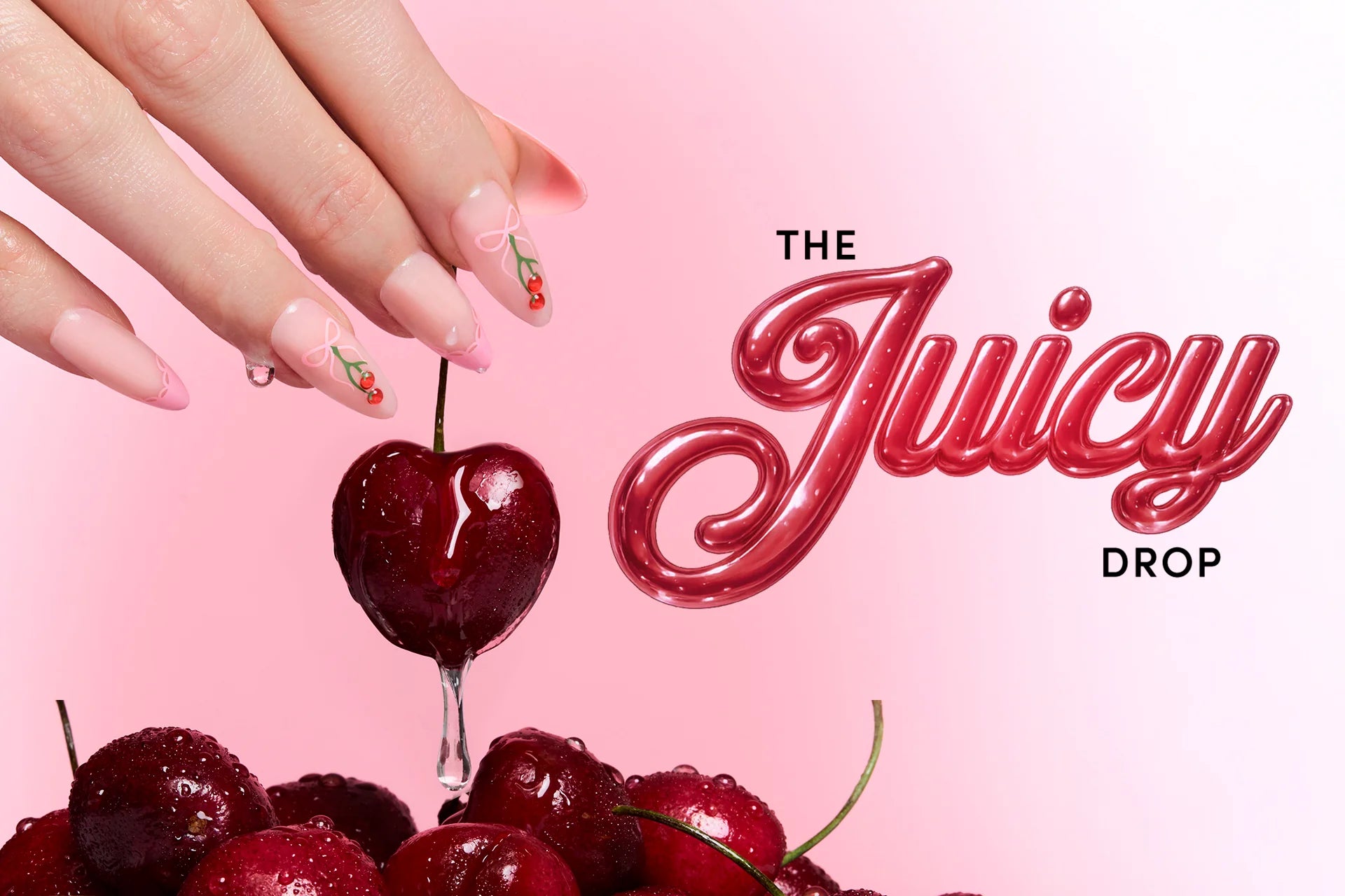 A hand with long pink nails holding a cherry with the text "The Juicy Drop"