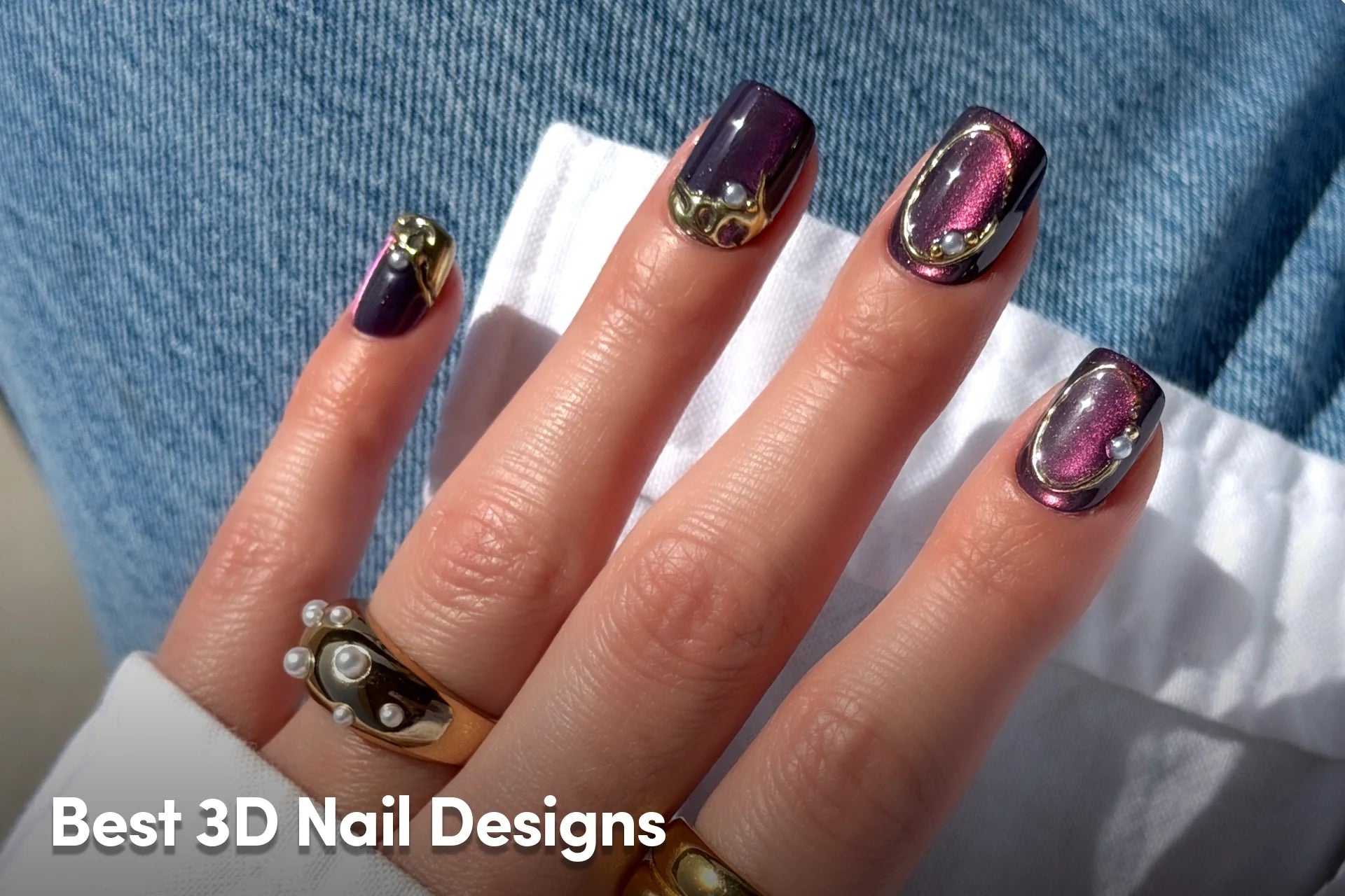 Metallic purple 3D nails with sculpted gold accents and pearl details.