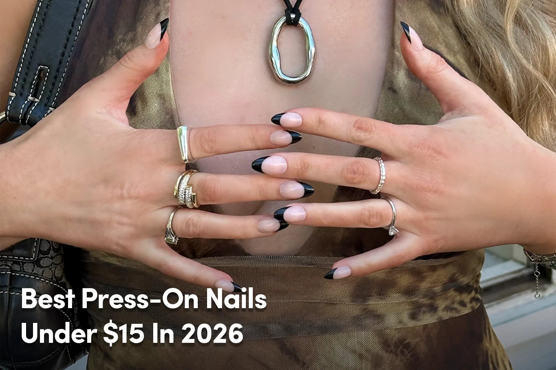 Black French tip press-on nails with silver rings.