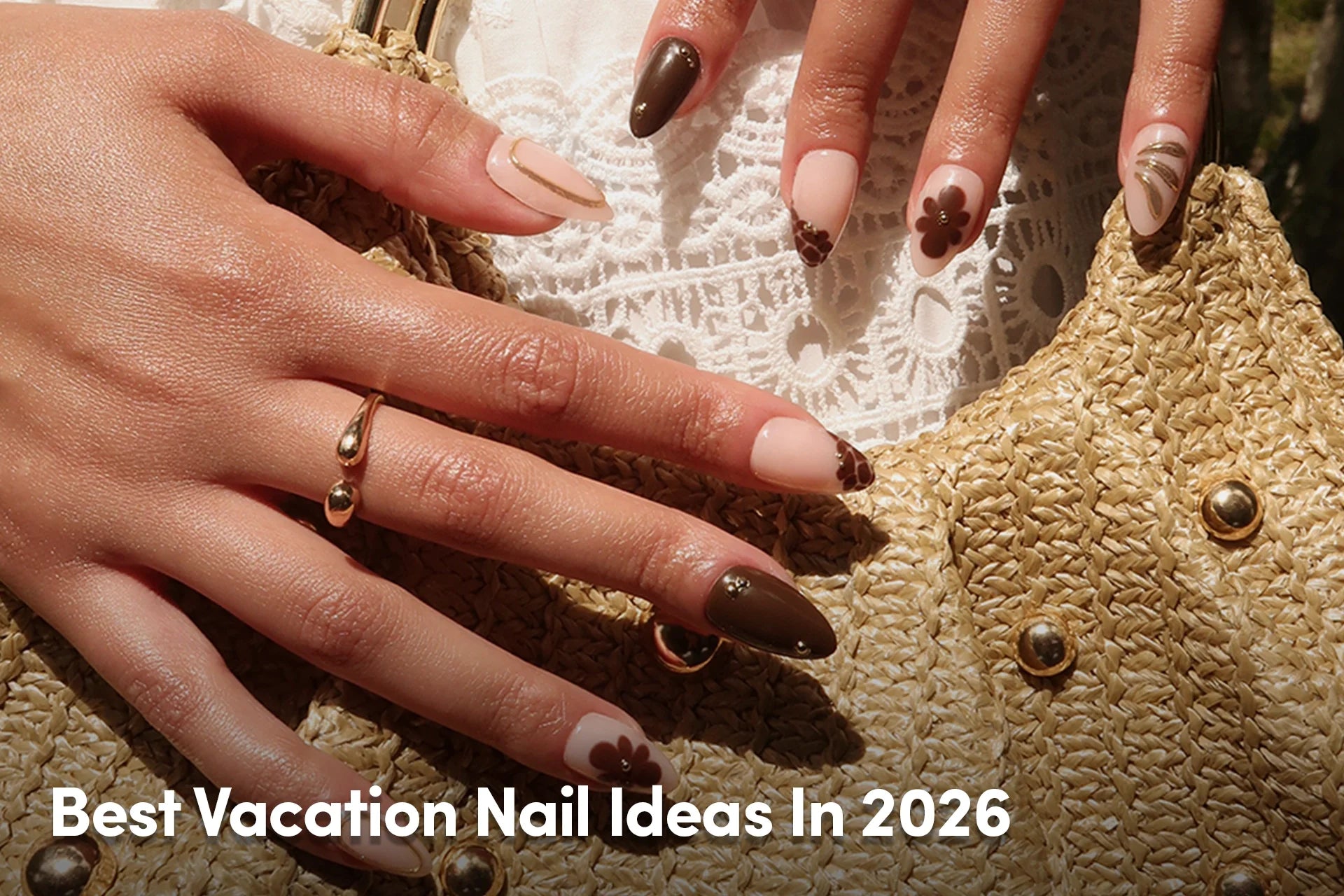 Brown floral nail art with nude accents beside a woven beach bag.
