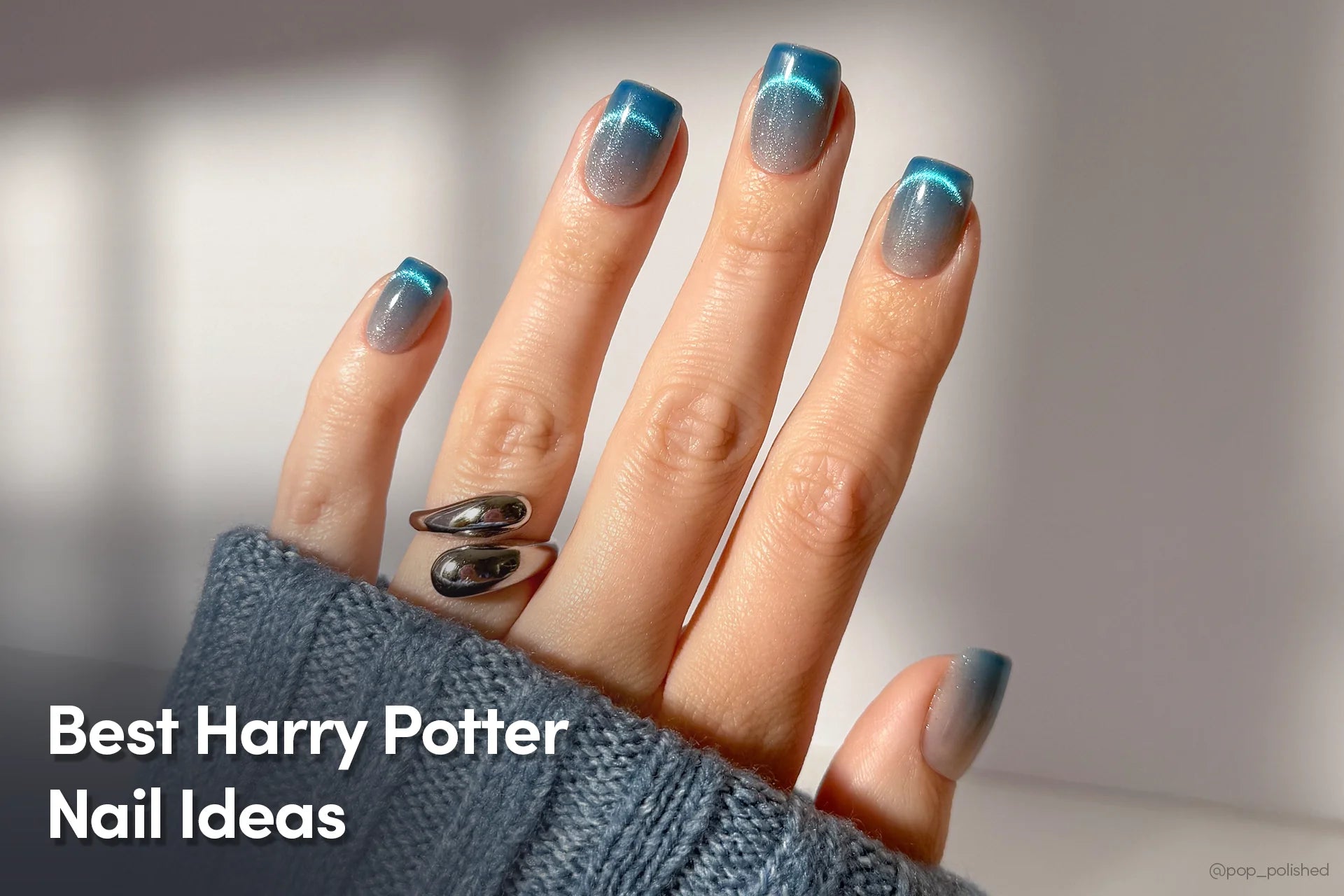 Close-up of a hand with glossy square-shaped blue press-on nails.