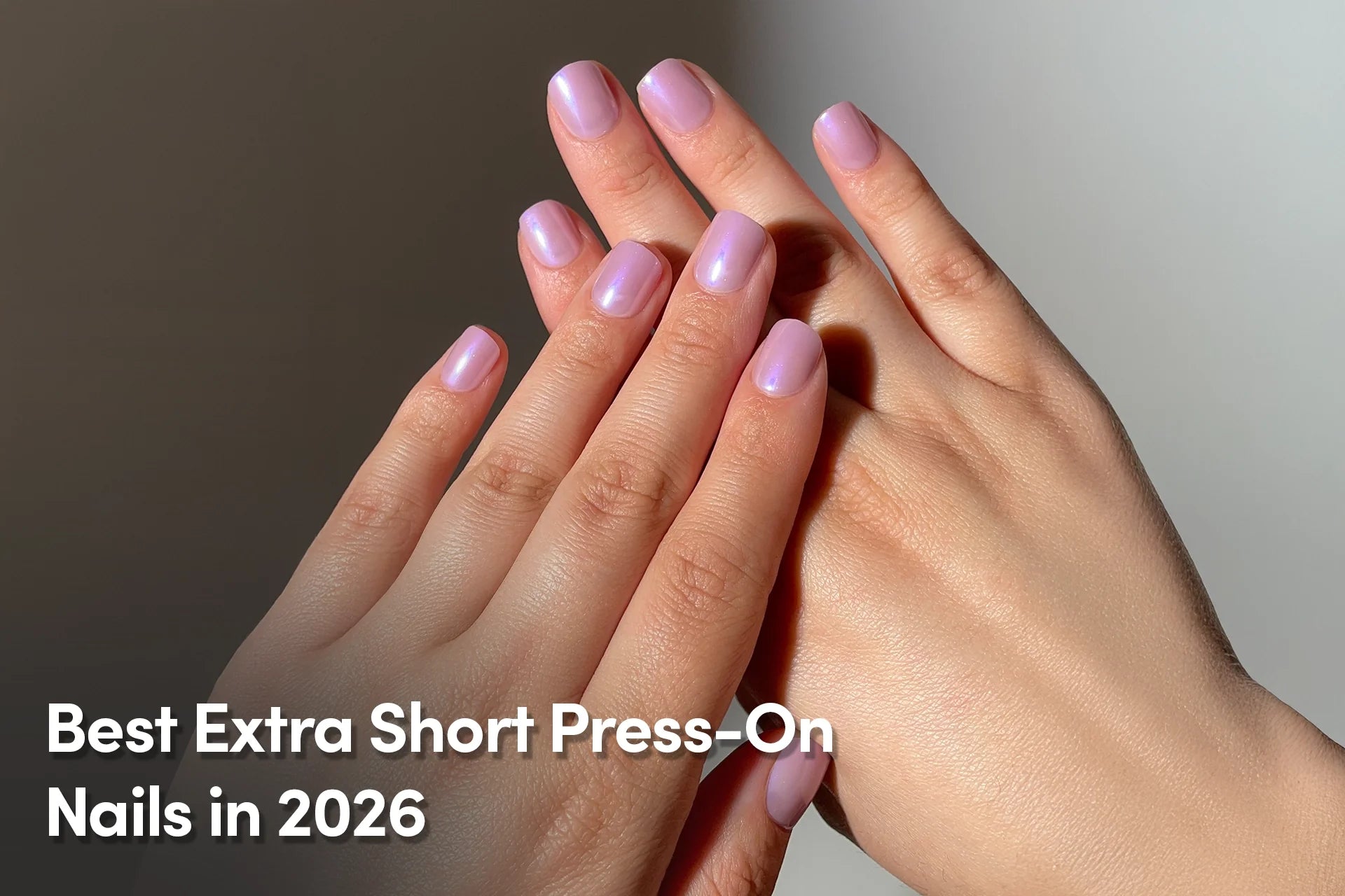 Hands with extra short lavender press-on nails in a glossy finish