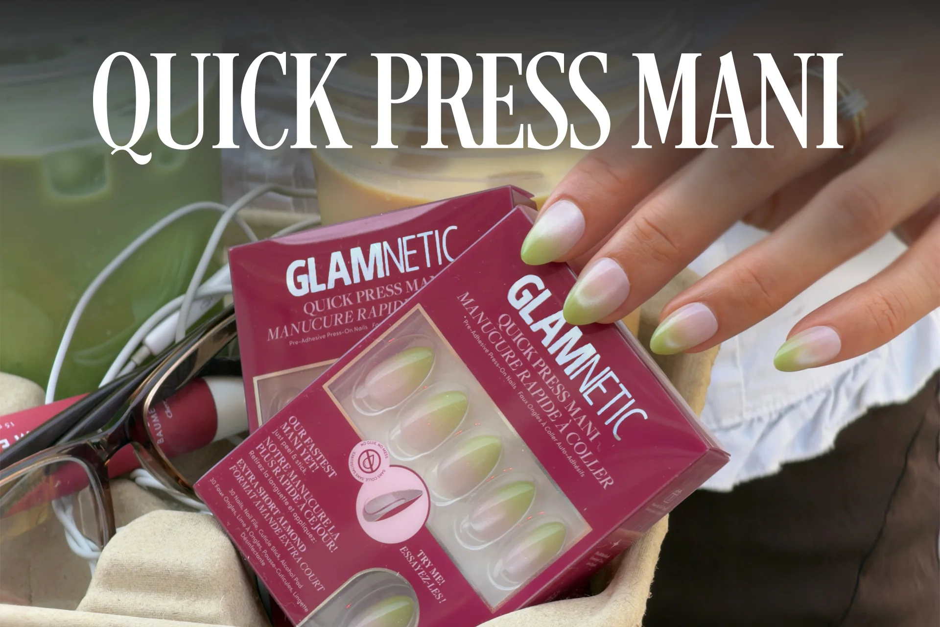 Glamnetic Quick Press Mani press-on nail set box held by a hand with green ombré nails.