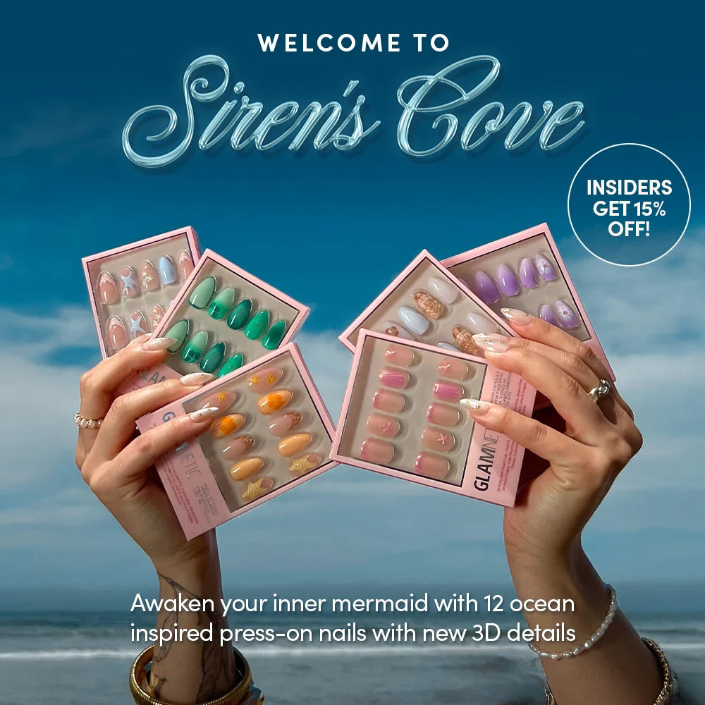 A person holds five packs of colorful press-on nails with ocean-inspired designs in front of a beach backdrop. Text reads Sirens Cove and Insiders get 15% off!.