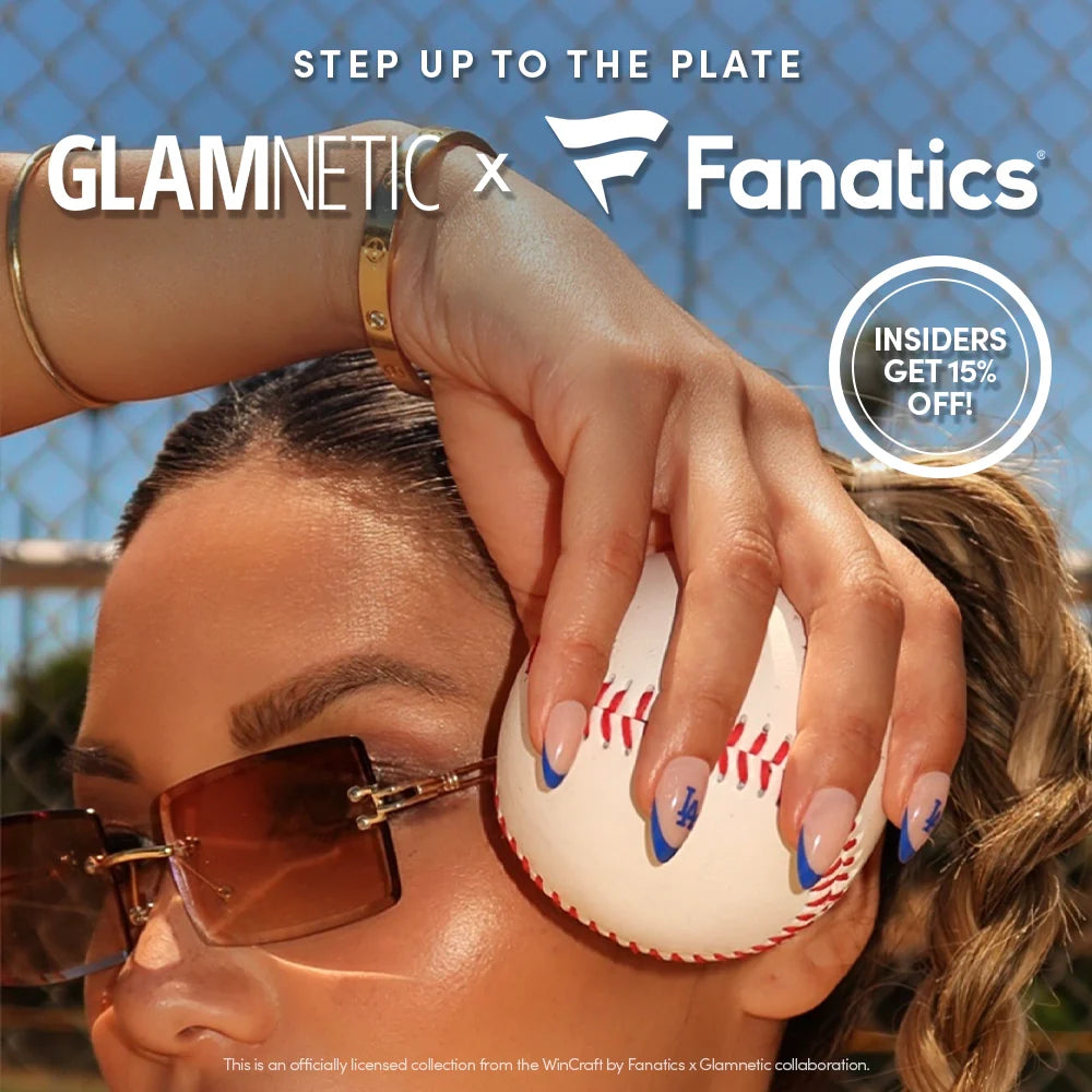 A woman wearing sunglasses holds a baseball with blue and white manicured nails. Text reads “GLAMNETIC x Fanatics” and “INSIDERS GET 15% OFF!” against a sunny, outdoor background.