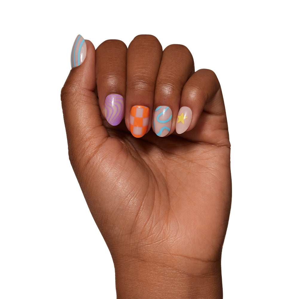 A hand with five short oval nails from glamnetics Wild Child set, each featuring colorful wavy blue lines, purple swirls, orange checkerboard, blue curves, and a yellow star on a sheer base, shown against a white background. - Product image