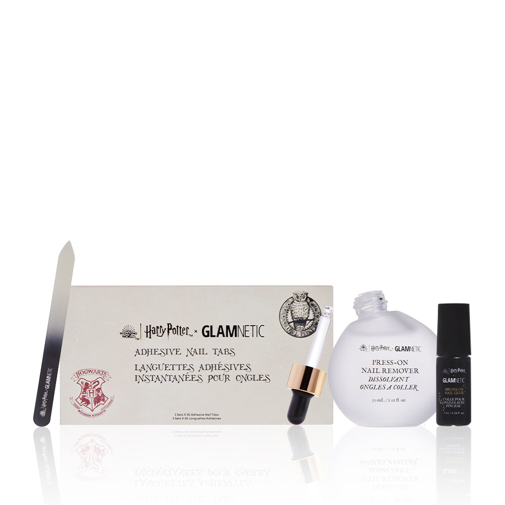 The glamnetic Concoction Ready set includes a crystal glass nail file, adhesive nail tabs, a press-on nail remover bottle with dropper, and a small black bottle, all arranged neatly against a white background.