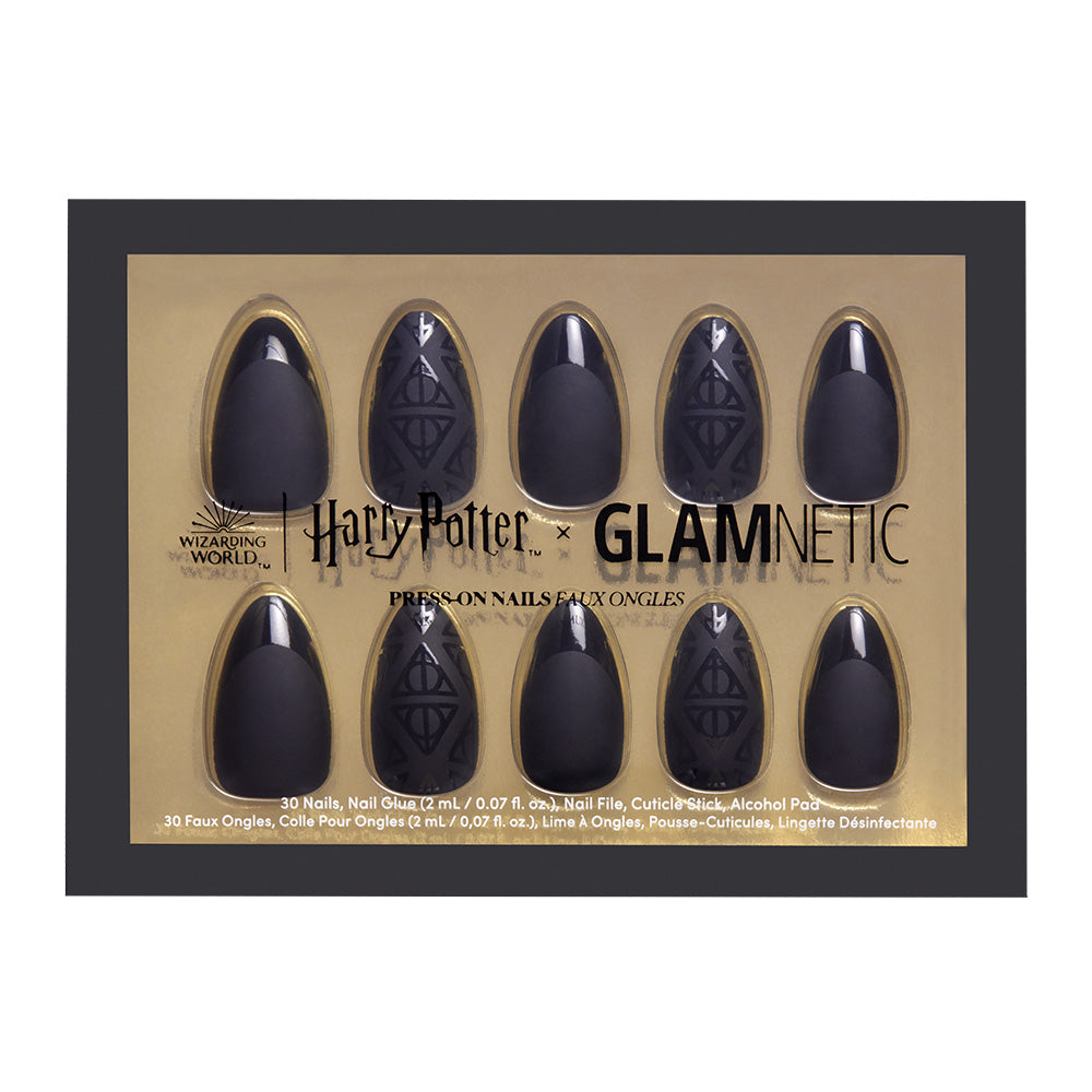 The Deathly Hallows™ press-on nails by glamnetic feature black nails with the iconic symbol, packaged in a sleek gold and black box—a must-have for any Wizarding World fan.