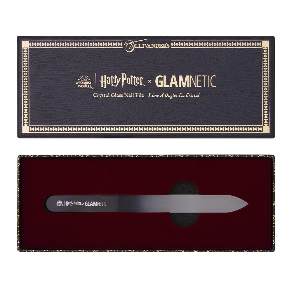 The Harry Potter™ Crystal Glass Nail File by glamnetic comes in an open dark box with gold edging, red velvet lining, and the Ollivanders logo. The black file features silver text—a magical press-on manicure essential. - Product image