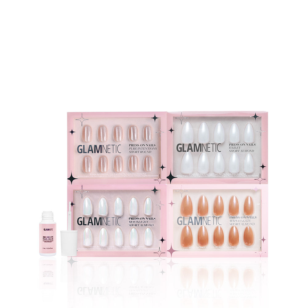 Four boxes of glamnetic Glaze It press-on nails in various colors, like Maple Glaze and Hailey Moonlight, are arranged in a grid. A small bottle of glamnetic nail glue with cap sits to the left. The pink packaging has star accents. - Product image