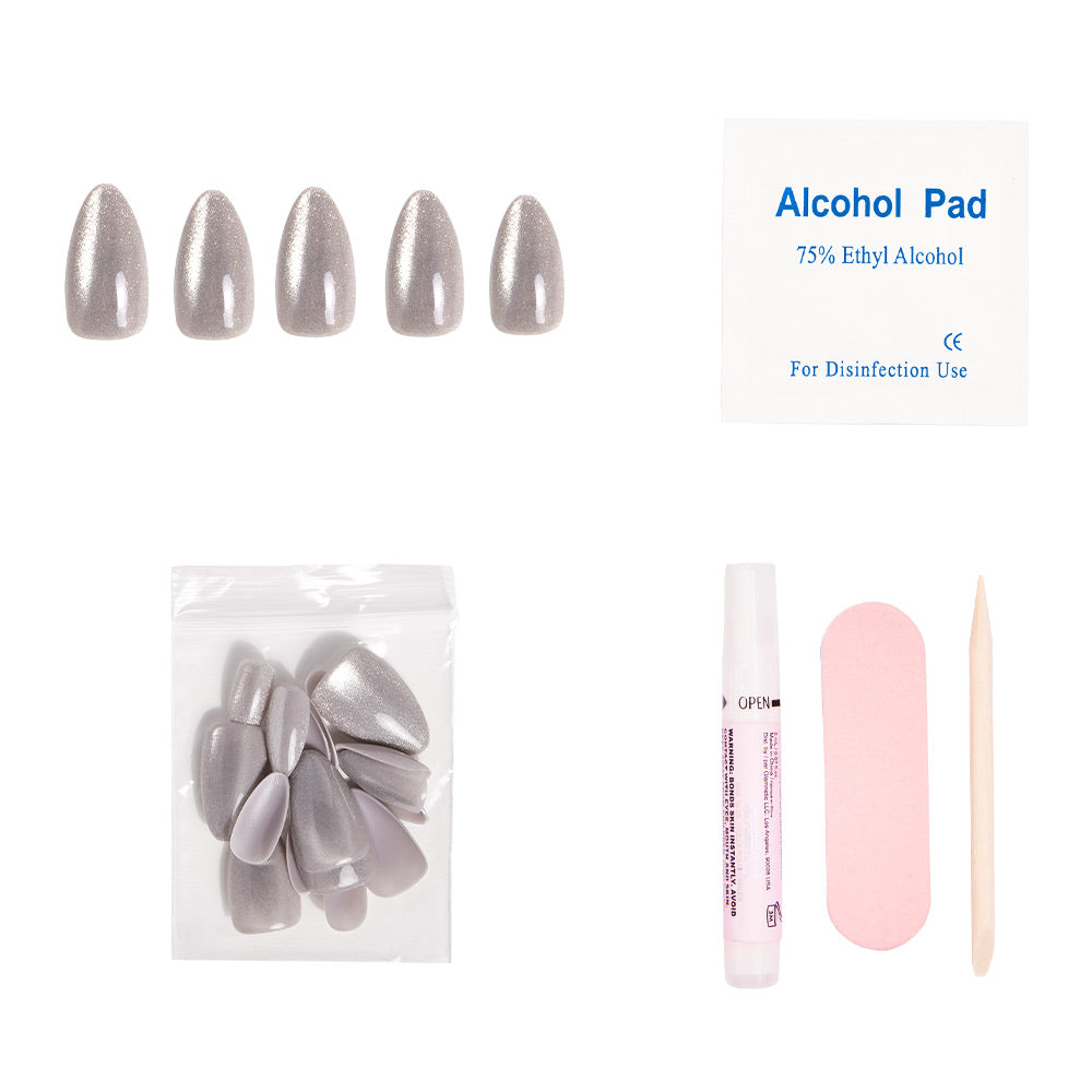 The glamnetic Oslo press-on nails kit features five short-almond, silver cat’s-eye nails, extra nails, an alcohol pad, nail glue tube, a pink nail file, and a wooden cuticle stick—all displayed on a white background. - Product image