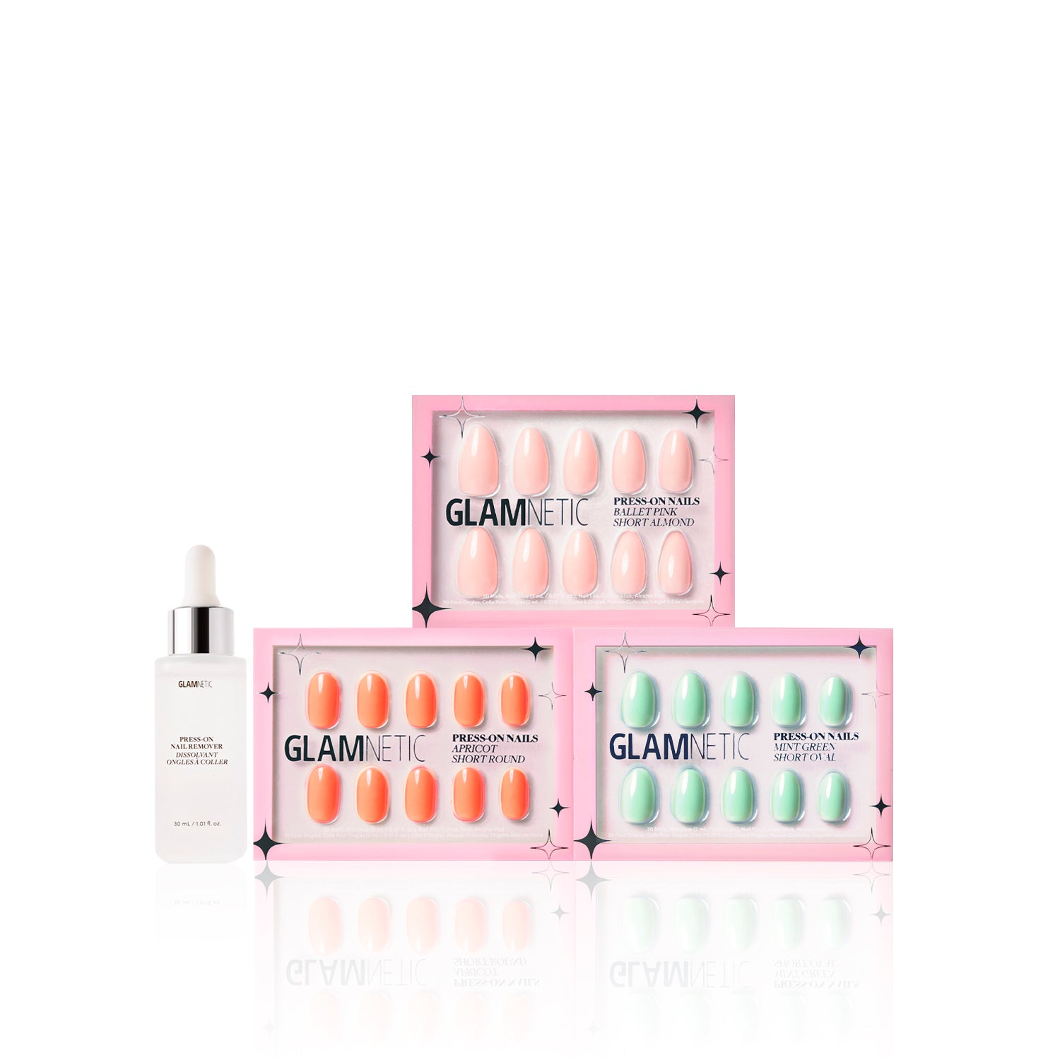 Three boxes of glamnetic Springtime Blooms press-on nails in Mint Green and Ballet Pink are stacked next to a glamnetic nail serum dropper bottle, all arranged on a white background. - Product image
