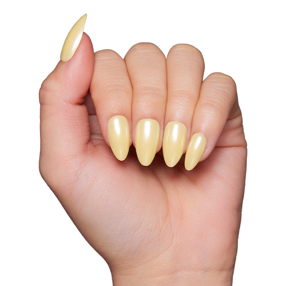 A hand with light skin tone showcases long, almond-shaped, glossy pastel yellow nails using the glamnetic Yellow Pop press-on nail set, displayed against a white background. - Product image