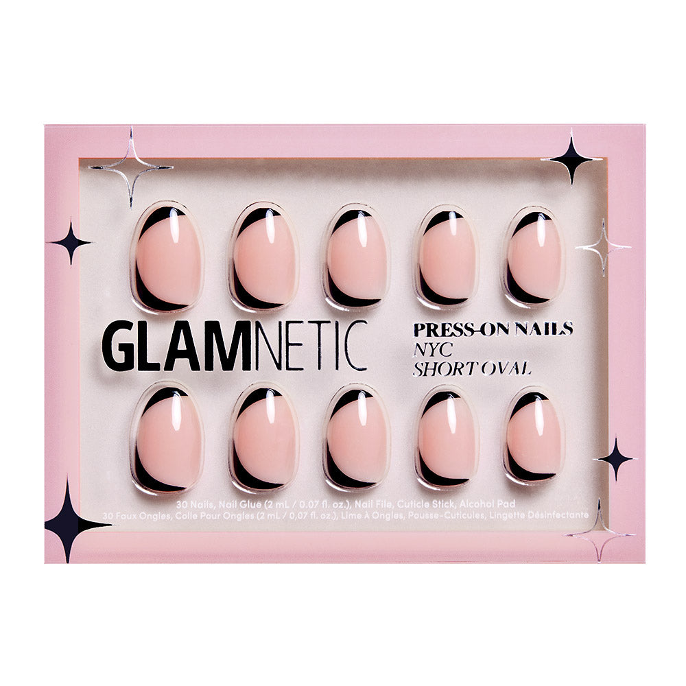 A box of glamnetic NYC Press-On Nails in short oval, featuring a glossy nude base with black French tips and an abstract design. The reusable nails come in pink packaging with black and white text and star accents.