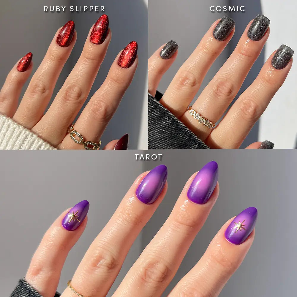 Three manicured hands display nail designs created with glamnetic’s Mystic Vision vegan nail set: red glitter (Ruby Slipper) press-on nails, silver-gray shimmer (Cosmic), and purple ombre with a gold star accent (Tarot), each in a flattering short almond shape and styled with gold rings.