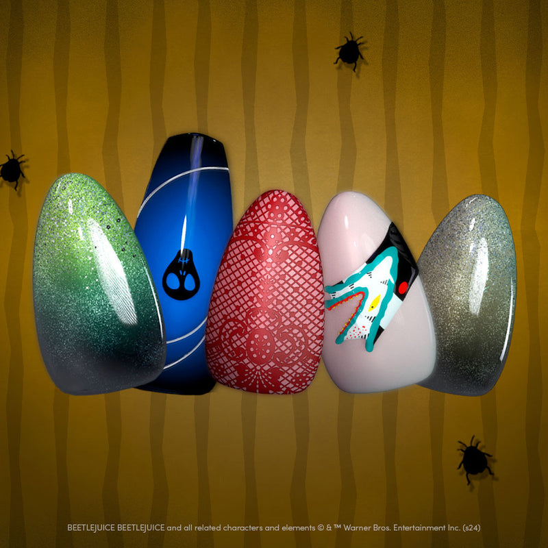 Close-up of five Glamnetic x Beetlejuice press-on nails featuring eerie designs in green, blue, red, white, and silver tones, displayed over a yellow striped background with small black beetles