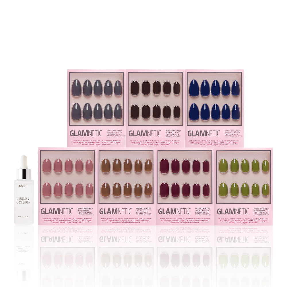 Seven sets from glamnetic’s The Solids Vol.3 Fall Forest Collection—vegan & cruelty-free nails in assorted fall shades—plus nail glue are displayed on a white background, with each pink box featuring a different short nail color. - Product image