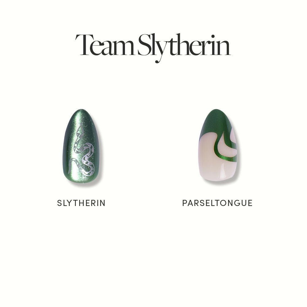Team Slytherin™ by glamnetic features two almond nails: one emerald green with a silver snake and SLYTHERIN, the other with green and beige swirls labeled PARSELTONGUE. Vegan and cruelty free.