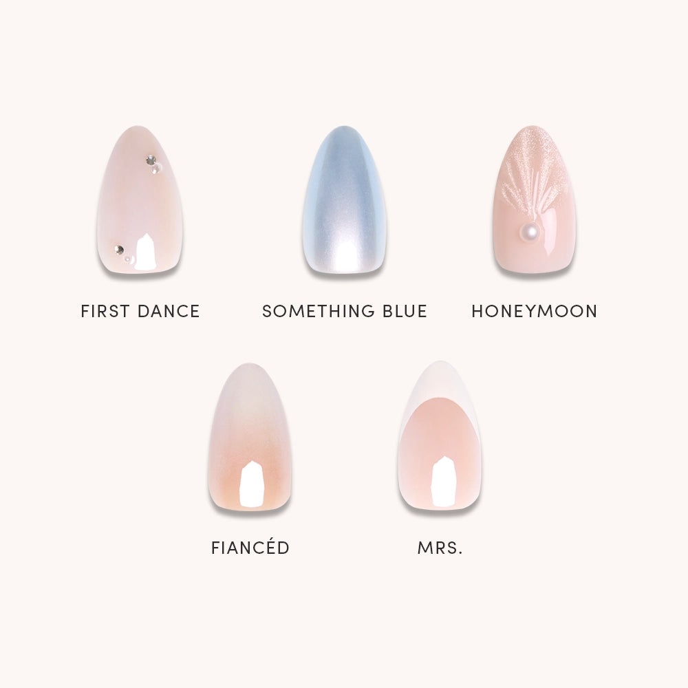 Anns Bridal Edit by glamnetic features five press-on nails—First Dance (pale pink with gems), Something Blue (shimmery blue), Honeymoon, Fiancé, and Mrs. (nude French tips)—perfect for any wedding celebration.