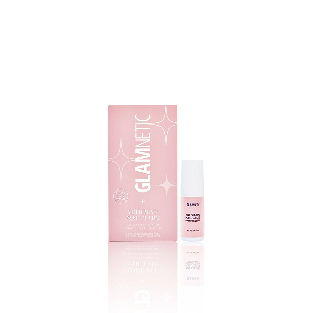 A pink glamnetic Pressed to Perfection box labeled Adhesive Nail Tabs sits beside a matching Brush-On Nail Glue bottle on a white background; both feature white text and a sleek, minimal design.