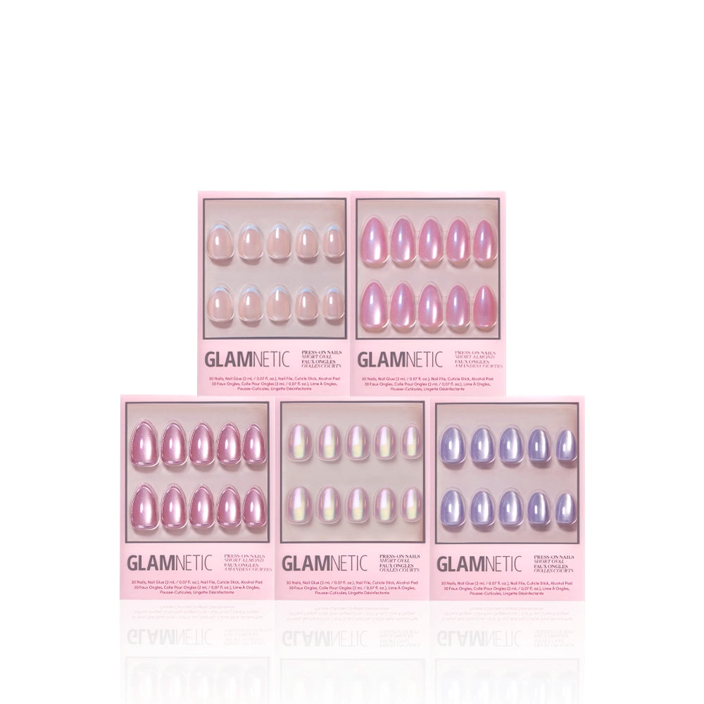Five boxes of glamnetic Shimmering Shores press-on nails in pastel pink, nude, iridescent, and lavender with a glazed finish are arranged in a pyramid on a white background. - Product image