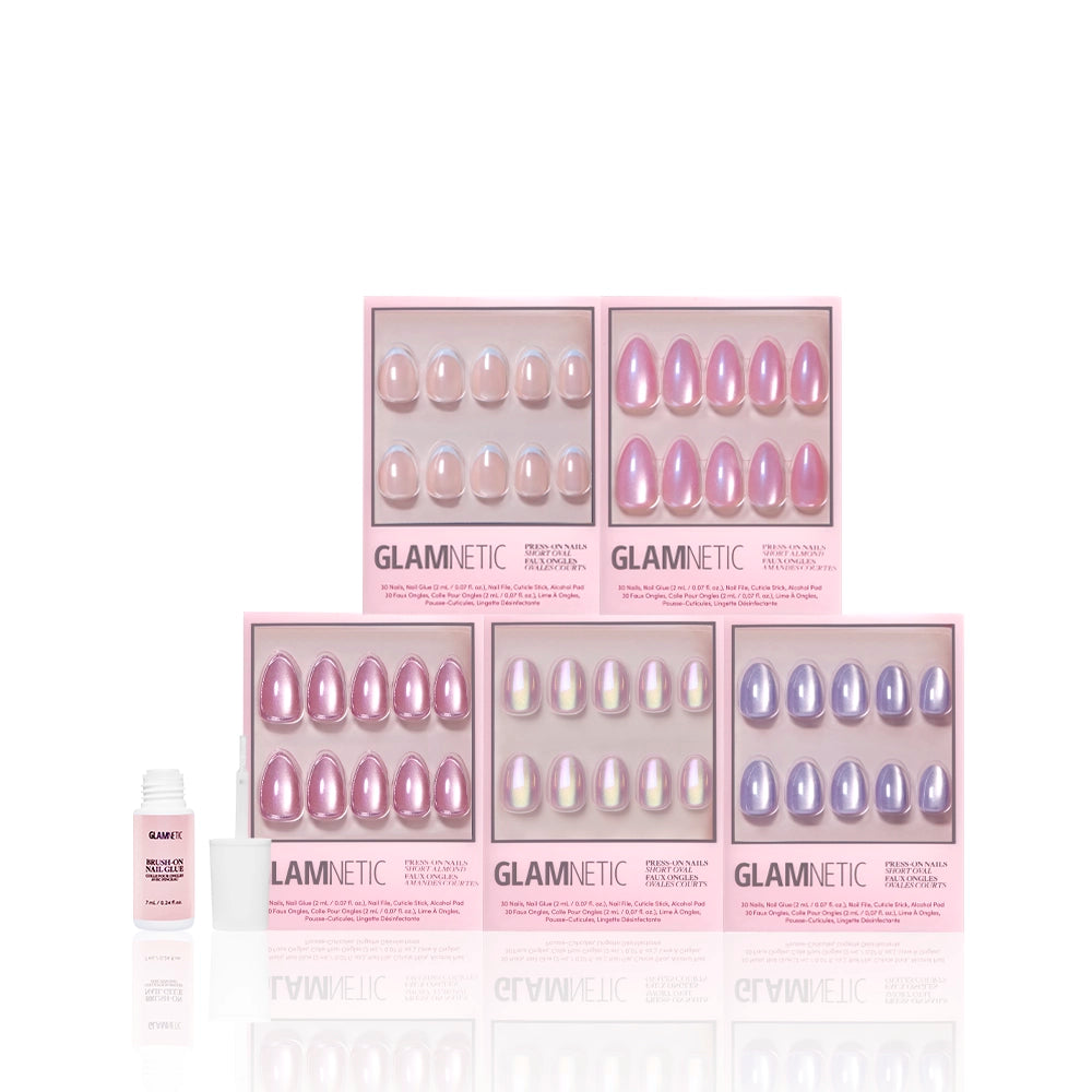 Five boxes of glamnetic Shimmering Shores press-on nails in pink and purple shades, some with a shimmering glazed finish, are arranged in two rows with a small bottle of nail glue on the left, all set against a white background. - Product image
