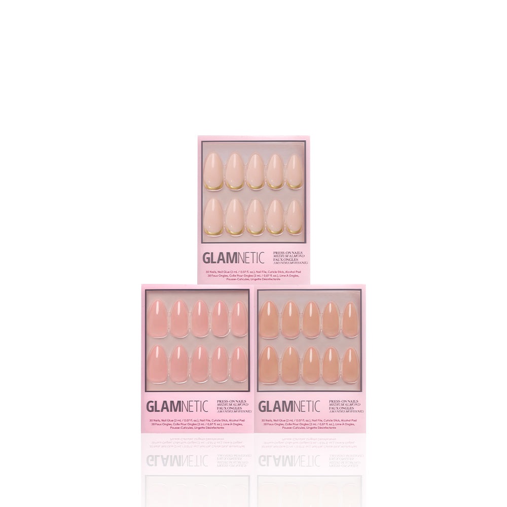 Three boxes of glamnetic’s The Almond Edit medium almond nails in sheer glossy neutrals, arranged pyramid-style on a white background. Each box features a clear window displaying the elegant, feminine nail sets inside. - Product image