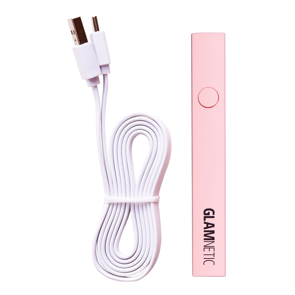A pink rectangular Handheld UV LED Lamp from glamnetic is shown beside a coiled white USB charging cable with dual connectors. - Product image