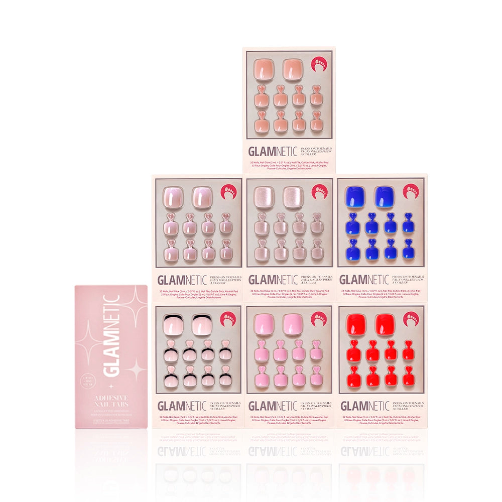 Bright & Light Hues Pedi Bundle from Glamnetic displayed with a pink box of adhesive nail tabs. Includes seven press-on toenail kits in assorted shades such as blue, red, pink, and nude, presented in a symmetrical layout - Product image
