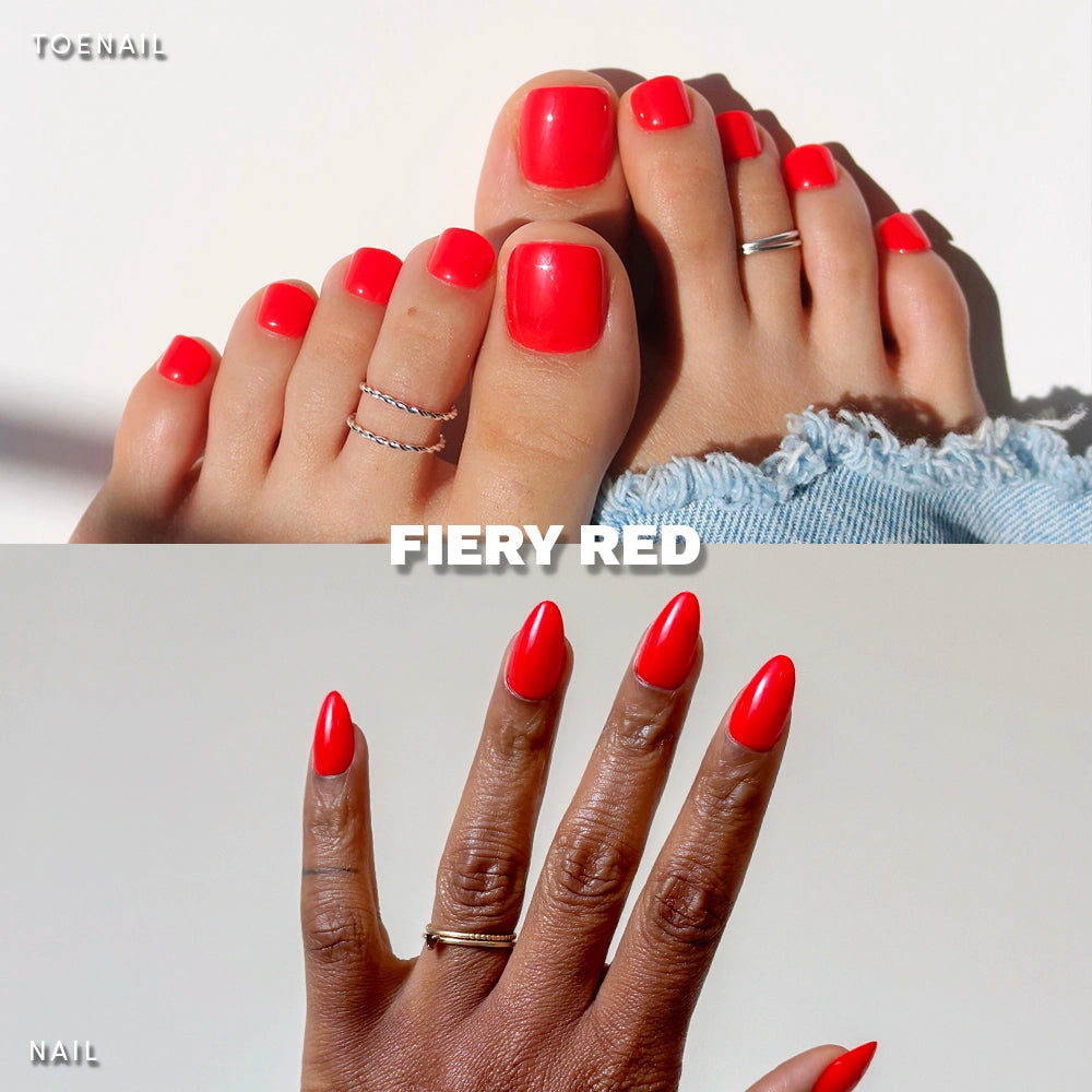 Glamnetic Fiery Red Mani & Pedi press-on nail set worn on real hands and feet. Features a glossy hot red base with bold black glitter detailing on square toenails and stiletto-shaped fingernails