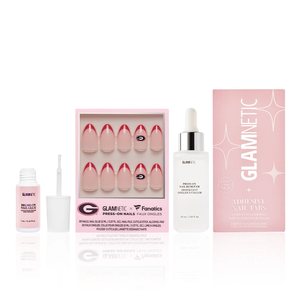 The Georgia Bulldogs Gameplan by glamnetic includes pink and white faux nails in a box, nail glue with applicator, a Press-on nail remover, and Adhesive Nail Tabs in a pink box.