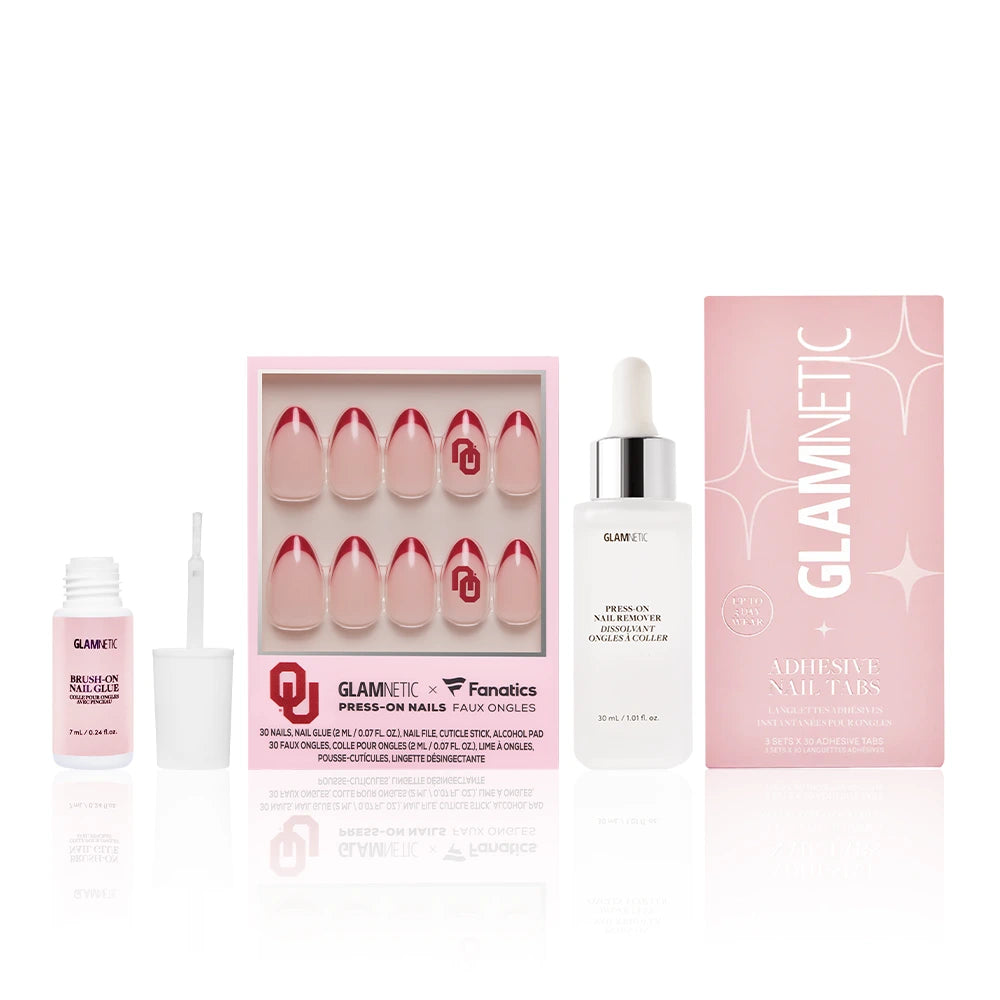 The Oklahoma Sooners Gameplan by glamnetic features press-on nails with pink tips, plus adhesive nail glue, a dropper of Press-on nail remover, and adhesive nail tabs—all in stylish pink and white packaging.