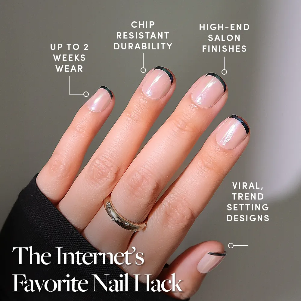 A hand with short, almond-shaped nails in glamnetic’s Burnt Miso, featuring minimalist black French tips and a glossy glazed finish. Enjoy up to 2 weeks wear, chip-resistant durability, salon-quality shine, and viral trendsetting style. - Product image