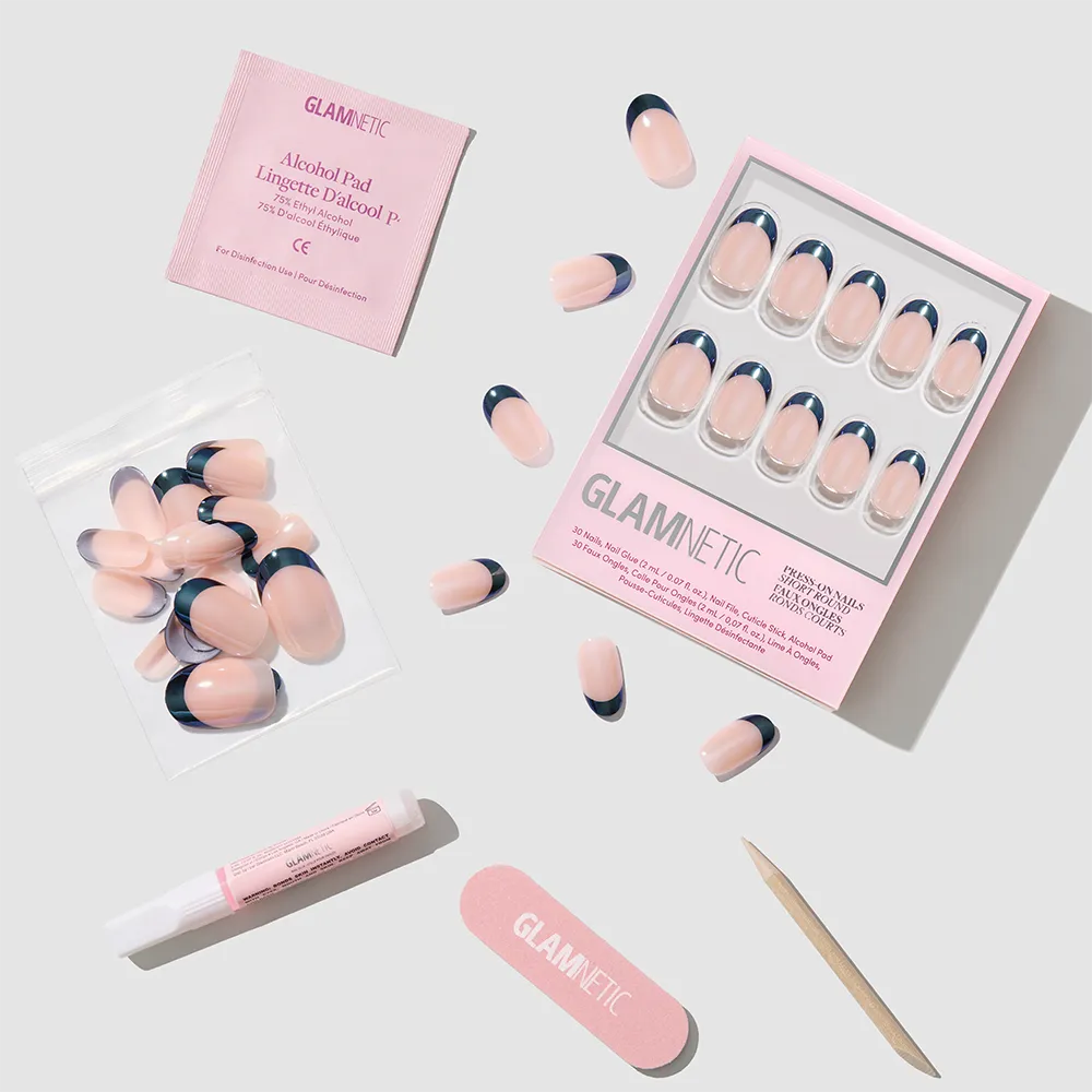 A set of glamnetic Onyx Glaze pink press-on nails with navy blue French tips, glossy finish, nail glue, file, cuticle stick, alcohol pad, and extra nails are arranged neatly on a light background. - Product image