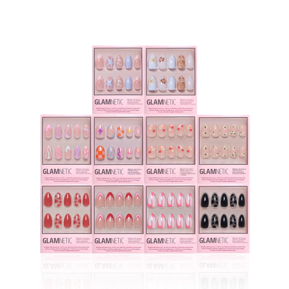 Nine boxes of glamnetic’s Trendy Not Spendy press-on nails, featuring trending designs and short almond options, are arranged in a pyramid on a white background. Each box shows a unique nail style through a clear window. - Product image