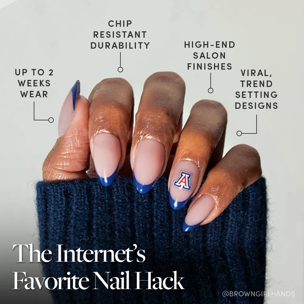 A hand with long almond-shaped nails, featuring navy French tips and an A logo accent, showcases the glamnetic Arizona Wildcats Press-On Nail Set—durable, chip-resistant, salon-quality press-ons with trendy two-week wear. - Product image