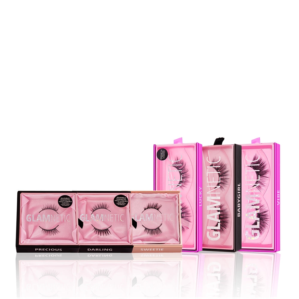 Three pink rectangular glamnetic Lash Out Loud boxes are displayed side by side, with three more standing upright behind them. Each box has reusable lashes in unique styles, including dramatic cat-eye lashes. - Product image