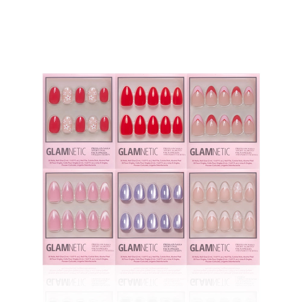 Six boxes of glamnetic's Romantic Resolutions press-on nails are displayed in two rows, each featuring salon-quality designs in red, nude, pink, and lavender with sparkle or marble patterns. - Product image